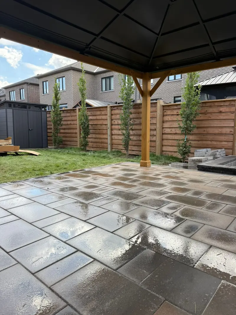 Paver walkway alongside cedar privacy fence