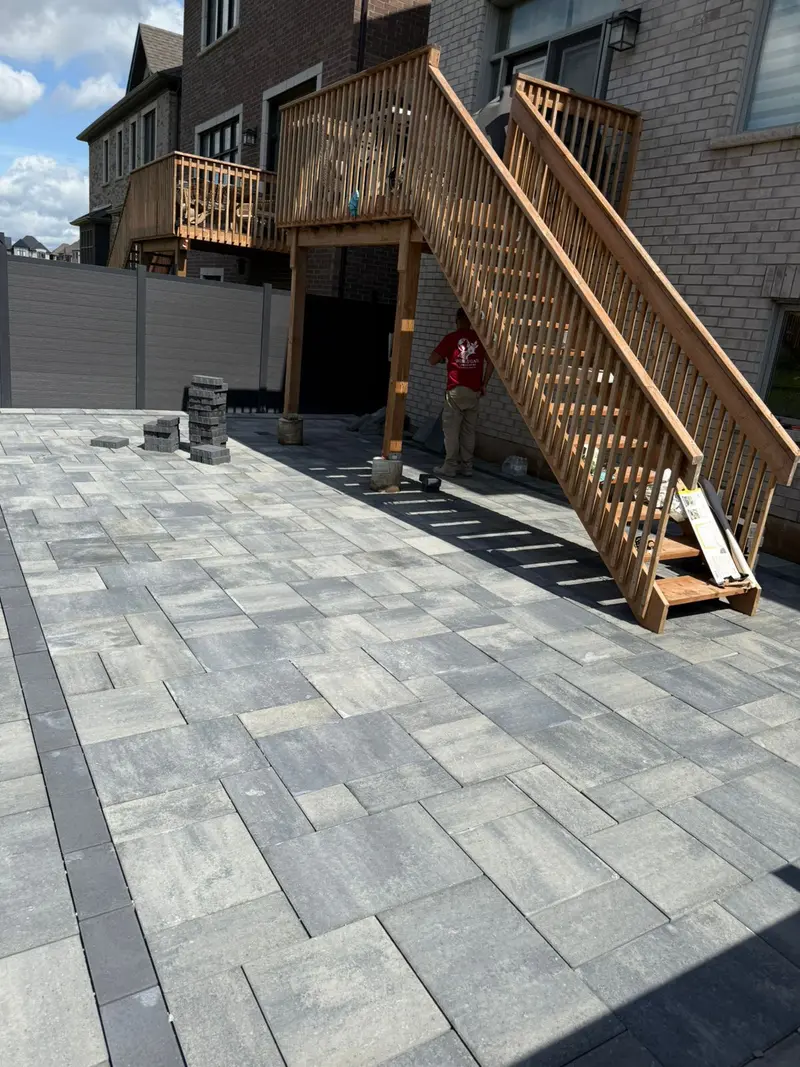 Large interlocking patio with deck stairs in GTA home