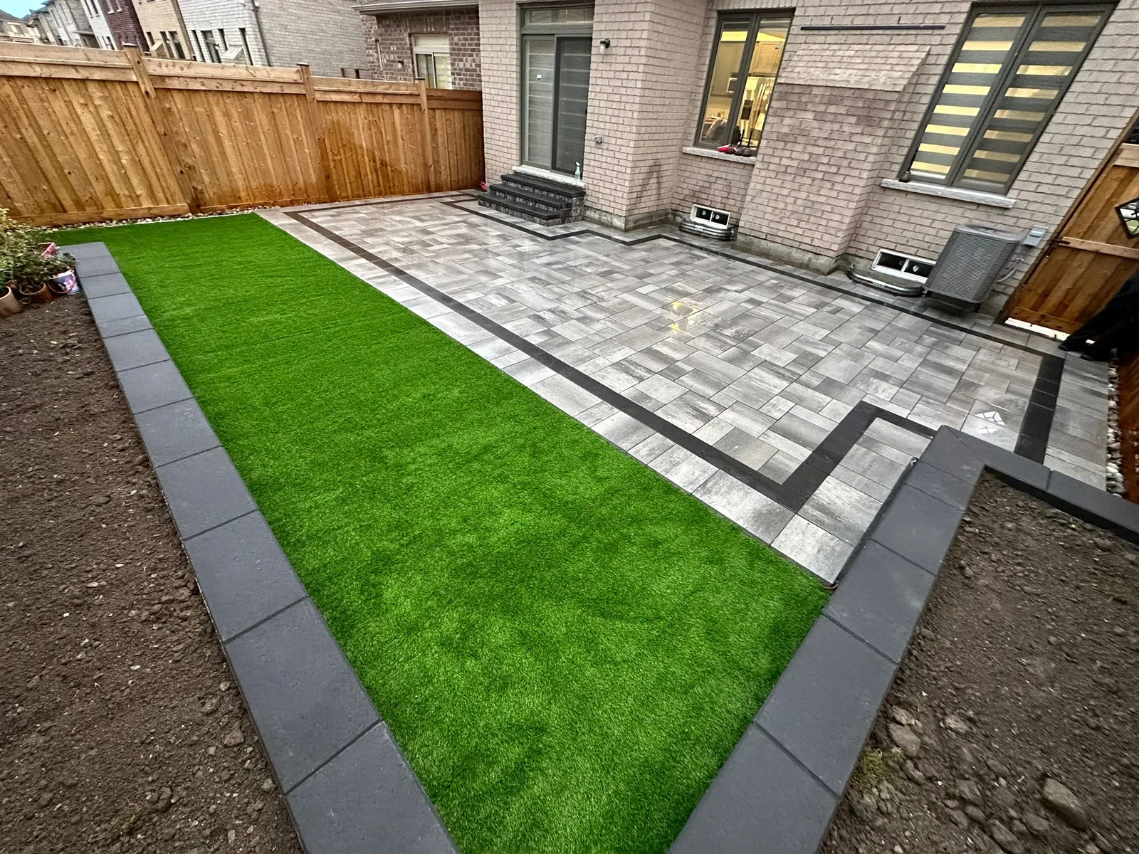 Backyard patio with layered landscaping